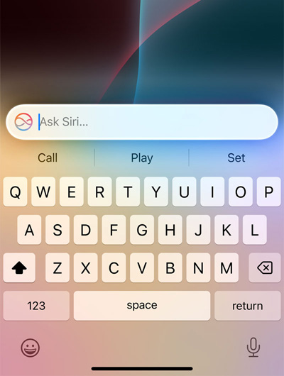 A text field at the top of keyboard in iPhone says Ask Siri