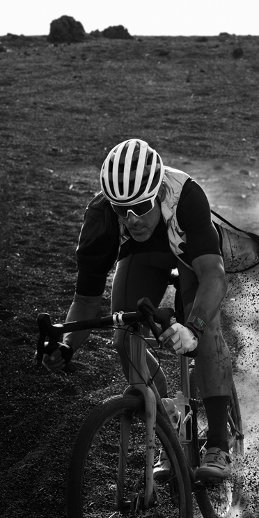 A man biking while wearing Apple Watch Ultra 2.