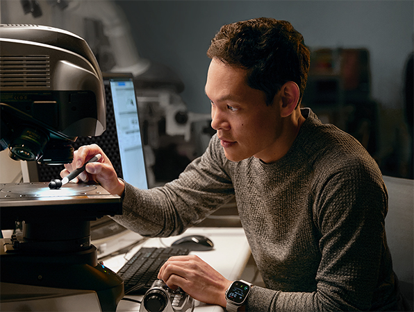 An Apple engineer testing hardware in a lab.