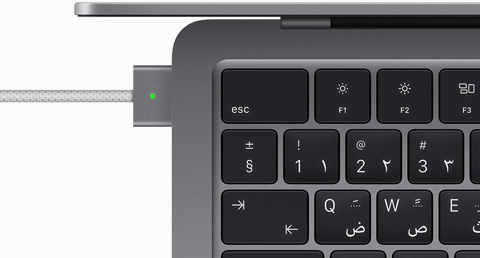 Top view showing MagSafe cable plugged into MacBook Air in Space Gray color