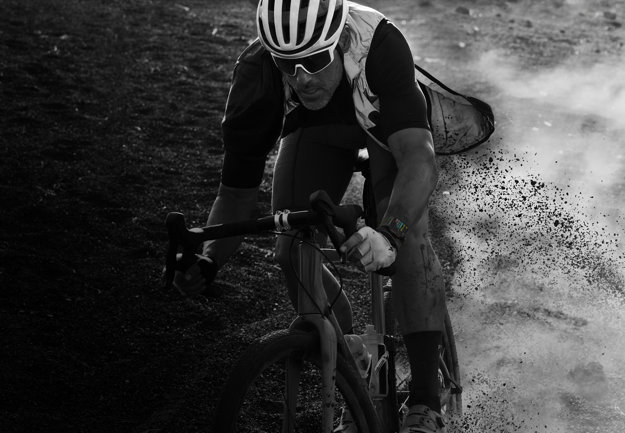 A person riding a bicycle down a rocky trail wearing Apple Watch Ultra 2.