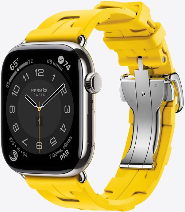 Angled view of the rubber Kilim band in Sun (yellow) showing the quick-release metal buckle and the Hermès Circulaire watch face.