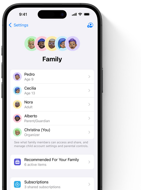 iPhone screen showing the Family page in Settings, Memojis of individual family members, each set against its own colorful circle, arrayed at the top, same Memojis in a list beneath them showing all members of the Family Sharing group