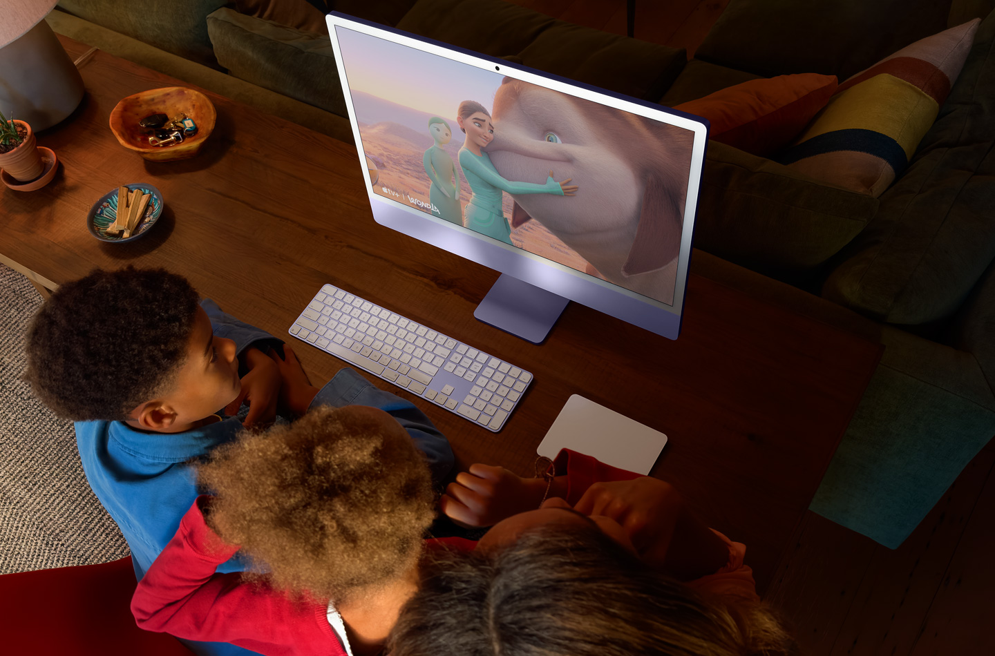 Three children watching WondLa show on iMac